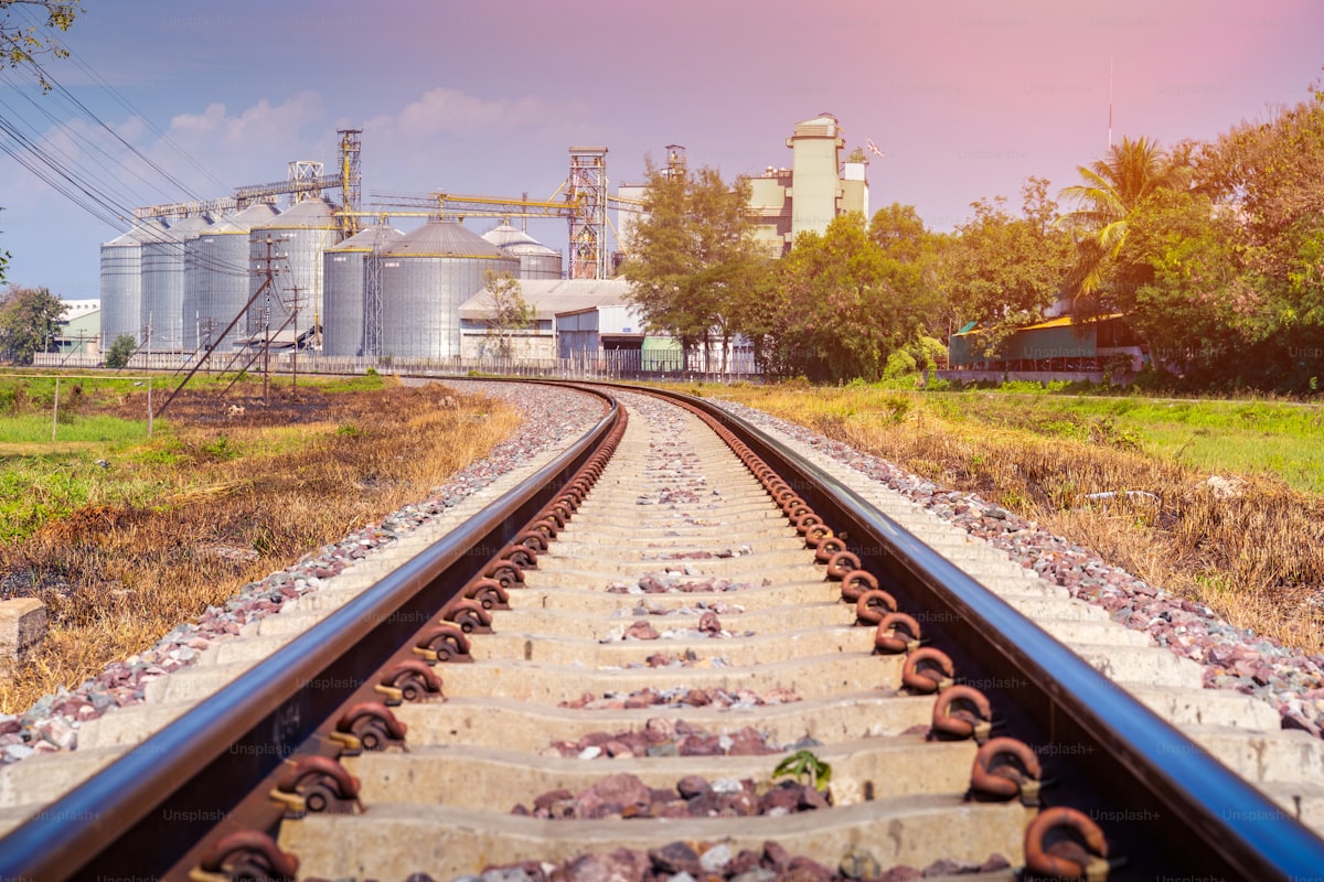 Railroad tracks leading to grain elevator and industrial silo facility